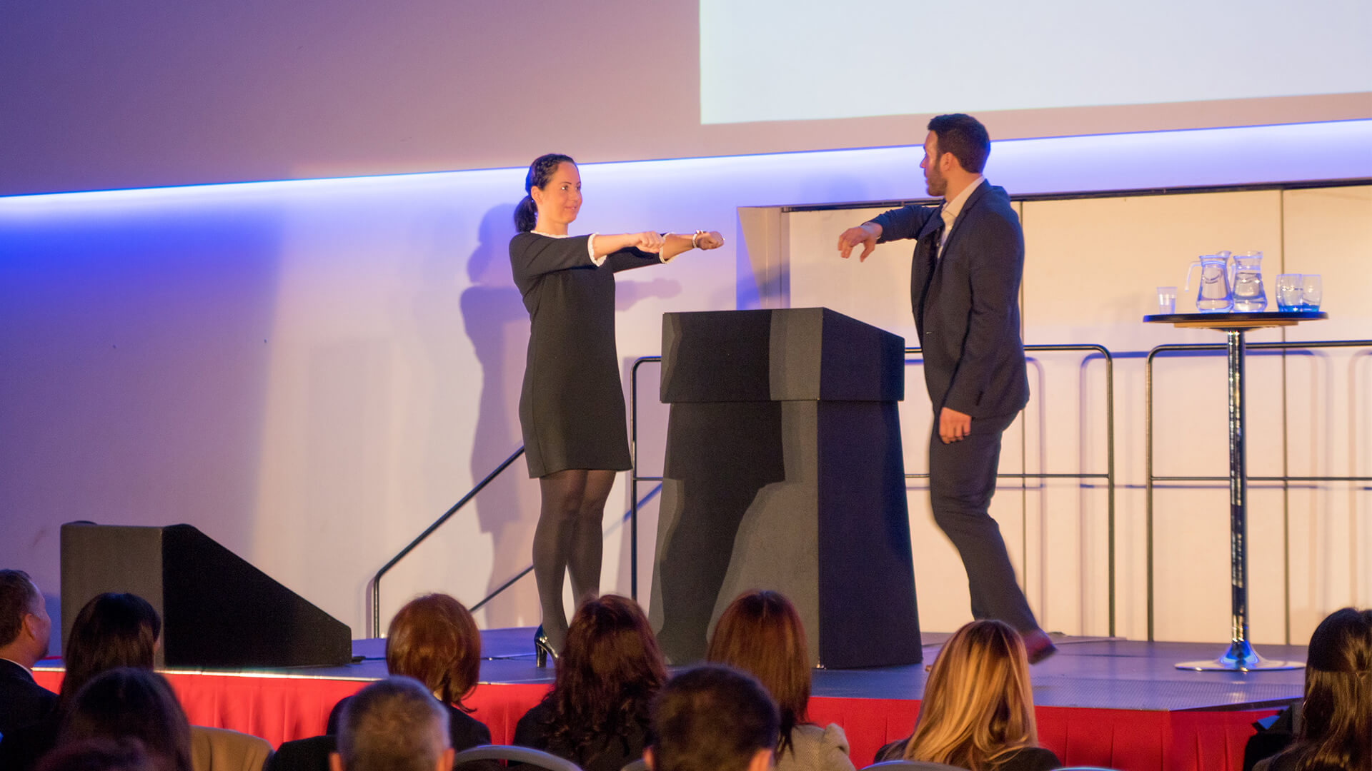 Aaron demonstrating the psychology of business on stage at Corporate event as Manchester magician