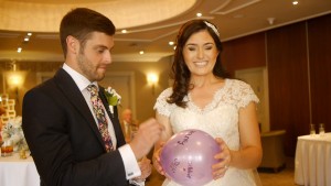 Manchester wedding magician popping a balloon
