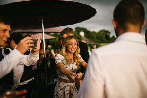 Manchester magician aaron calvert giggling with girl at manchester wedding making a group laugh